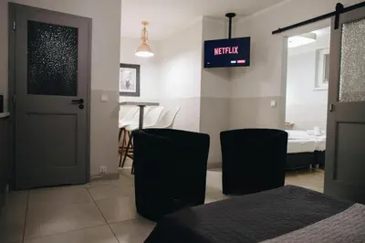 a room with a door and two chairs and a table at M7 Main Square with Free Parking Friends Escape in Kraków
