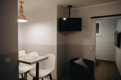 a small room with a table and chairs and a tv at M7 Main Square with Free Parking Friends Escape in Kraków