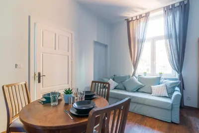 a living room with a table and a couch at Oak Tree Old Town Apartments in Kraków