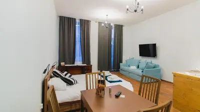 a living room with a table and a dining room at Oak Tree Old Town Apartments in Kraków