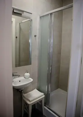 a bathroom with a shower and a sink and a tub at Oak Tree Old Town Apartments in Kraków