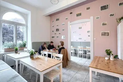 two people sitting at tables in a restaurant at Native Apartments Starowiślna 33A Deluxe in Kraków