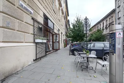 a sidewalk with a table and chairs on a street at Native Apartments Starowiślna 33A Deluxe in Kraków