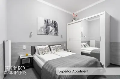 a bedroom with two beds and a mirror at PRIMERO Elegant Apartments KRAKÓW Old Town in Kraków