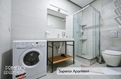 a bathroom with a washing machine and a toilet at PRIMERO Elegant Apartments KRAKÓW Old Town in Kraków