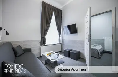 a living room with a couch and a bed at PRIMERO Elegant Apartments KRAKÓW Old Town in Kraków