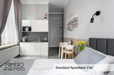 a kitchen and a bedroom with a bed and a table at PRIMERO Elegant Apartments KRAKÓW Old Town in Kraków