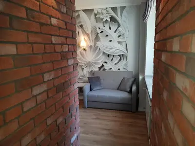 a brick wall with a couch in a room at Cracowapart Ignacio B in Kraków