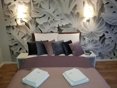 a bedroom with a bed with two towels on it at Cracowapart Ignacio B in Kraków