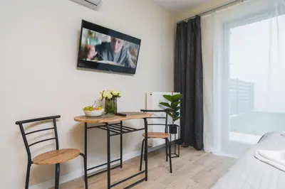 a living room with a table and two chairs at Sarah Apartments Old Town in Kraków