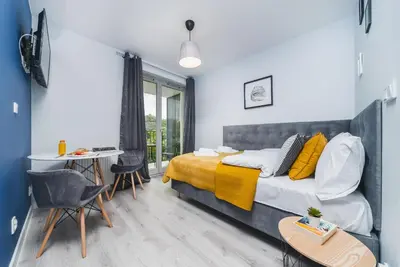 a bedroom with a bed and a table and chairs at Sarah Apartments Old Town in Kraków