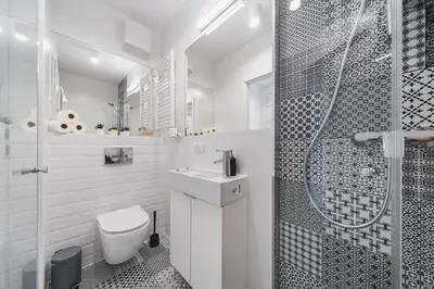 a bathroom with a shower and a toilet and a sink at Sarah Apartments Old Town in Kraków