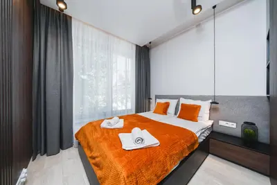 a bedroom with a bed with two towels on it at Sarah Apartments Old Town in Kraków