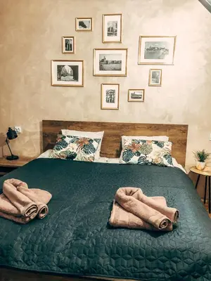 a bedroom with a bed with towels on it at Royal flats Old Town in Kraków