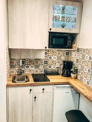 a kitchen with a sink and a microwave at Royal flats Old Town in Kraków