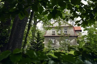 an old house in the middle of a forest at 29 Avenue Apartments in Kraków