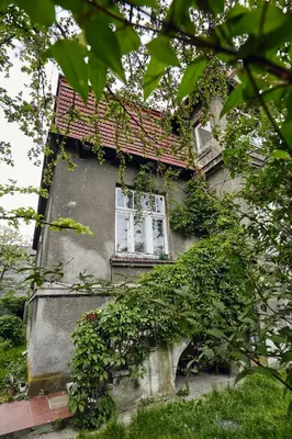 an old house with a red roof and a window at 29 Avenue Apartments in Kraków