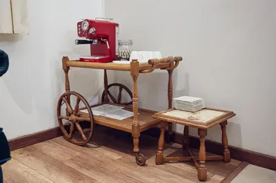 a wooden cart with a red sewing machine on it at 29 Avenue Apartments in Kraków