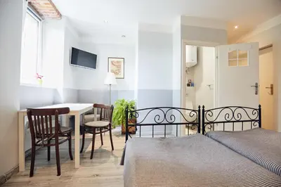 a bedroom with a bed and a table and chairs at 29 Avenue Apartments in Kraków