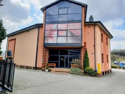 a building with a sign on the side of it at Apartament Kleopatra in Limanowa