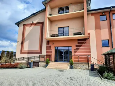 a large building with a staircase in front of it at Apartament Kleopatra in Limanowa