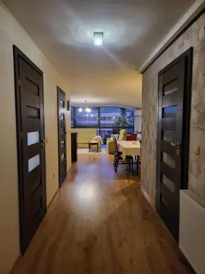 a hallway with a living room and a dining room at Apartament Kleopatra in Limanowa