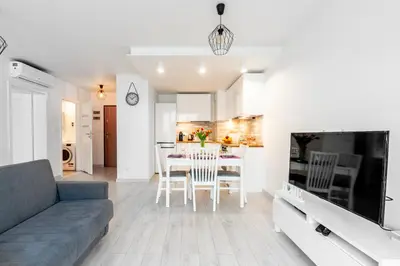 a living room with a couch and a table with chairs at Bella Casa Premium Apartment - 30 Pszczelna in Kraków