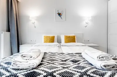 a bedroom with a bed with towels on it at Bella Casa Premium Apartment - 30 Pszczelna in Kraków