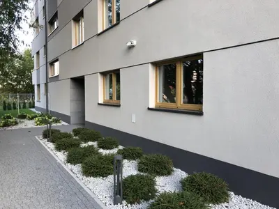 a building with a row of plants in front of it at Bella Casa Premium Apartment - 30 Pszczelna in Kraków
