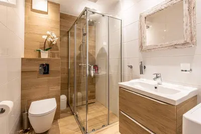 a bathroom with a shower and a sink and a toilet at Bella Casa Premium Apartment - 30 Pszczelna in Kraków
