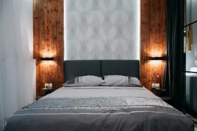 a bedroom with a large bed with wooden walls at Vistula Terraces Apartment in Kraków