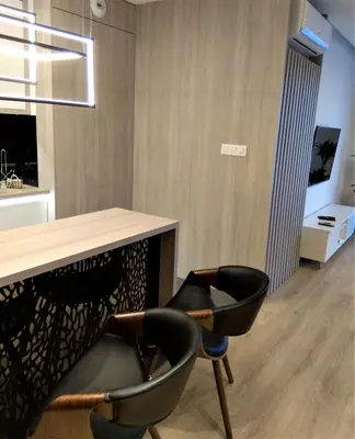 a dining room with two chairs and a table at Vistula Terraces Apartment in Kraków