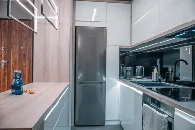 a kitchen with a stainless steel refrigerator and a sink at Vistula Terraces Apartment in Kraków