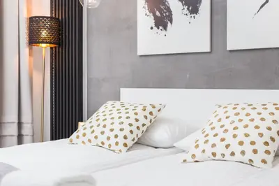 a bedroom with a bed with polka dot pillows at City of the Kings-Bacalar Apartment in Kraków