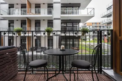a patio with a table and chairs on a balcony at City of the Kings-Bacalar Apartment in Kraków
