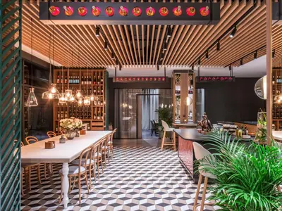 a restaurant with tables and chairs and wine racks at ibis Styles Kraków East in Kraków