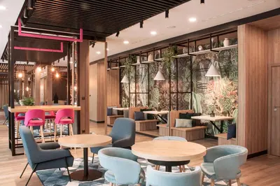 a conference room with a long table and chairs at ibis Styles Kraków East in Kraków