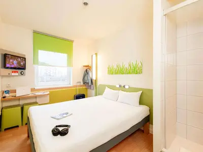 a person is reaching for a pair of white sneakers at ibis budget Krakow Stare Miasto in Kraków
