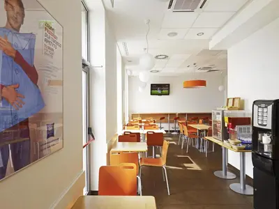 a bedroom with a white bed and a sink at ibis budget Krakow Stare Miasto in Kraków
