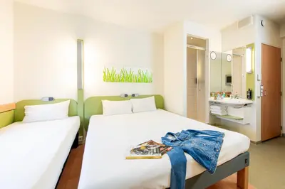 a room with a painting of a woman on a wall at ibis budget Krakow Stare Miasto in Kraków