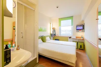 a hospital room with a bed and a sink at ibis budget Krakow Stare Miasto in Kraków