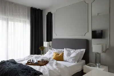 a bedroom with a bed with a tray on it at Fragola Apartments Rajska 3 - modern studios, park in Kraków
