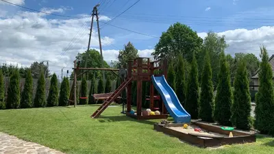 a playground in a yard with a slide at Country House - apartamenty blisko Energylandii in Spytkowice