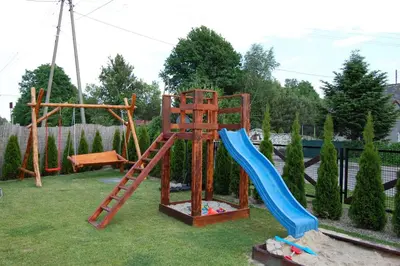 a playground with a ladder and a slide at Country House - apartamenty blisko Energylandii in Spytkowice