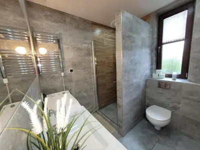 a bathroom with a shower and a toilet and a sink at Country House - apartamenty blisko Energylandii in Spytkowice