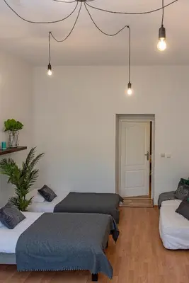 a room with four beds and a door at 3D Wawel Apartament in Kraków
