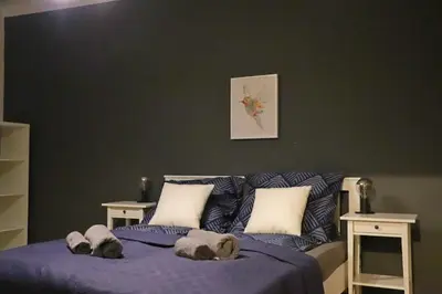 a bedroom with a purple bed with pillows at Szeroka View Apartment in Kraków