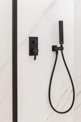 a shower in a bathroom with a black shower head at City of the Kings-Bijou Apartment in Kraków