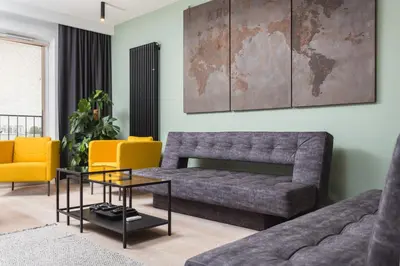 a living room with a couch and a table at City of the Kings-Bijou Apartment in Kraków