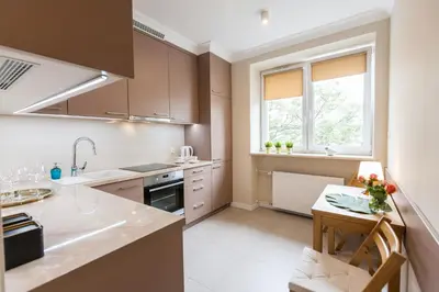 a kitchen with a sink and a table in it at Vintage Krasińskiego 7 Apartments in Kraków